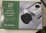 Brookstone Golfer's Digital Distance Scope With 5 X 20 Magnification. Fixed Price $9.99.